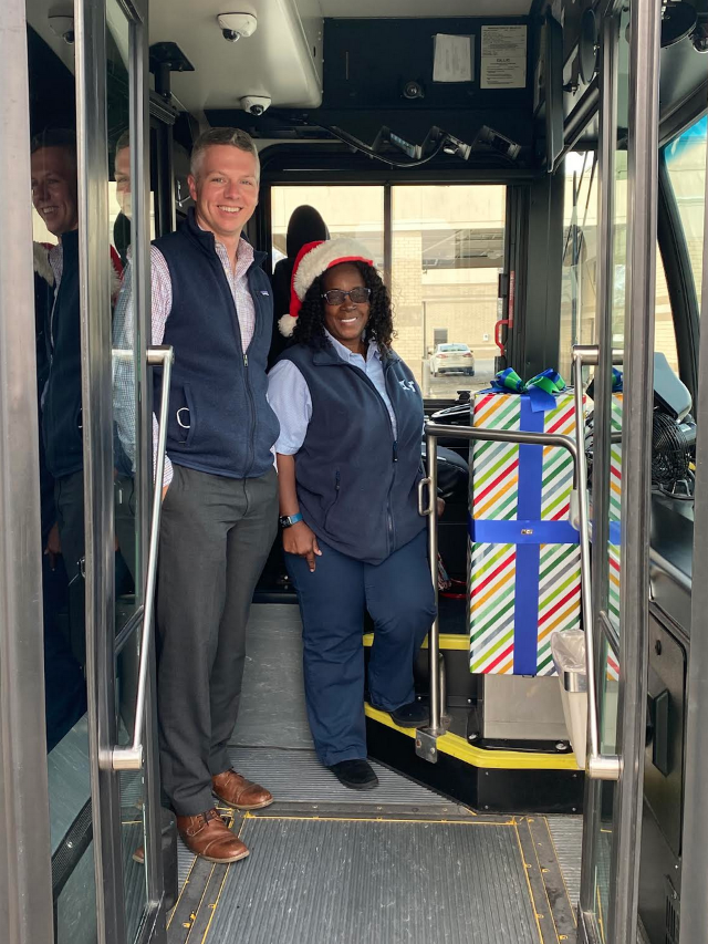  (Left to right): MCT Managing Director SJ Morrison and MCT Fixed-Route Bus Operator Carolyn Simmons, next to a decorated farebox on one of the new Holiday Buses.