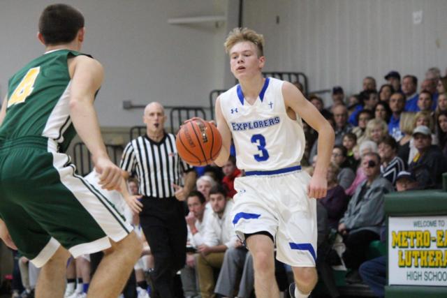 Marquette Catholic's Sammy Green handles the ball for the Explorers. (Photo by Madelaine Gerard)