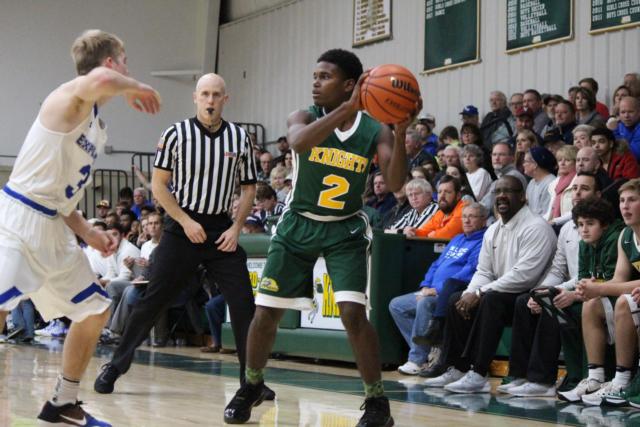 MELHS' Darion Brooks eyes to pass the ball inside. (Photo by Madelaine Gerard)