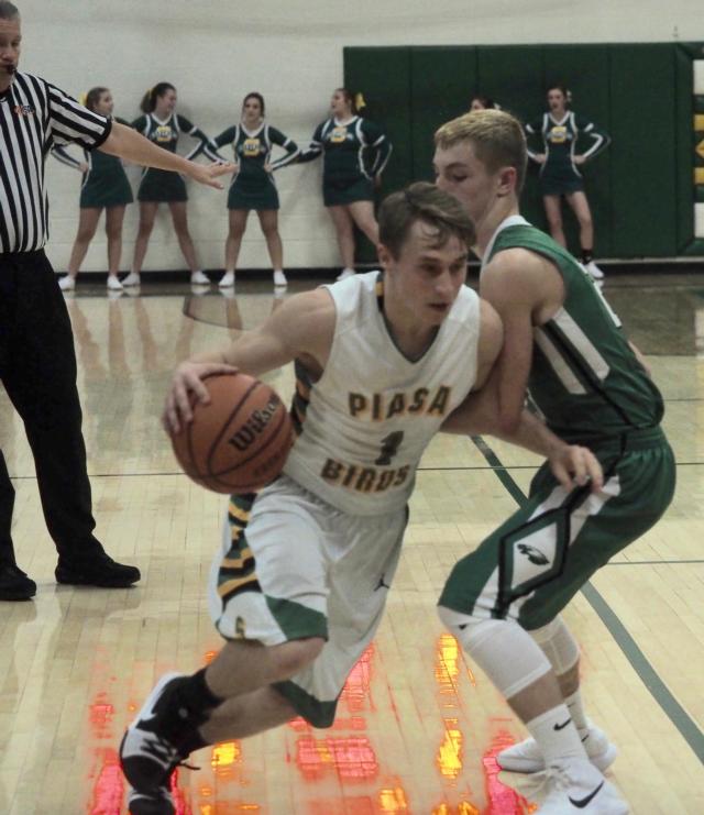 Southwestern's Justin Bailey (1) attempts to dribble past Carrollton's Nathan Walker in Piasa on Tuesday night.