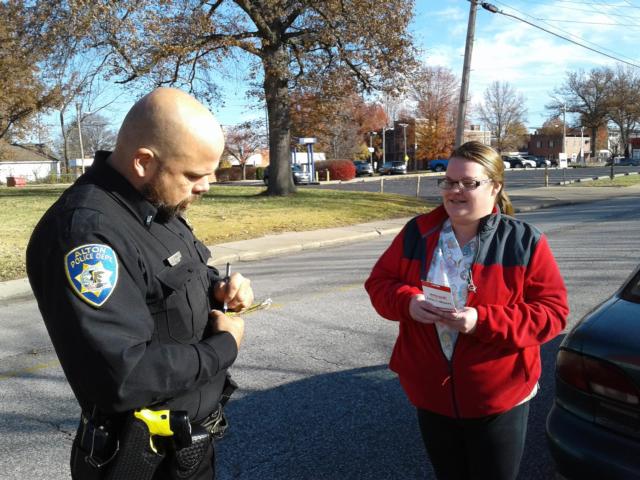 Motorist Allison Henderson receives a $50 to Save-A-Lot from Lt. Stinnett