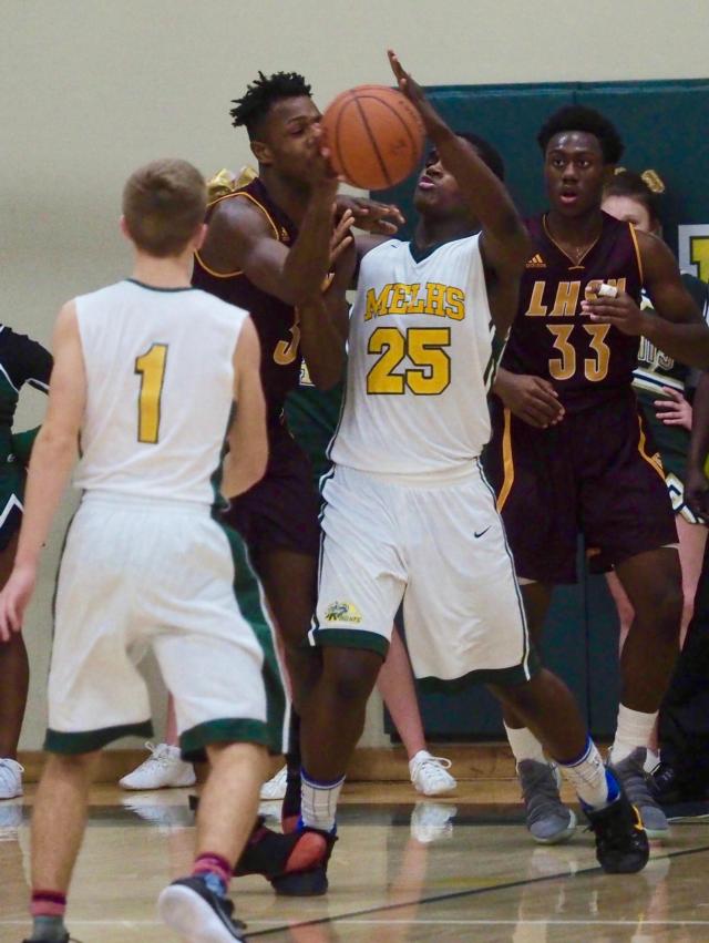 Jordan Nesbit drives to the basket that forces Damonte Bean to foul him .