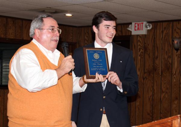 Alex Piazza, a senior at Alton High school, receives a Student of the Month Award from Rotary Club President John Hopkins at the club meeting in the banquet hall of Alton Sports Tap, Jan. 12. 