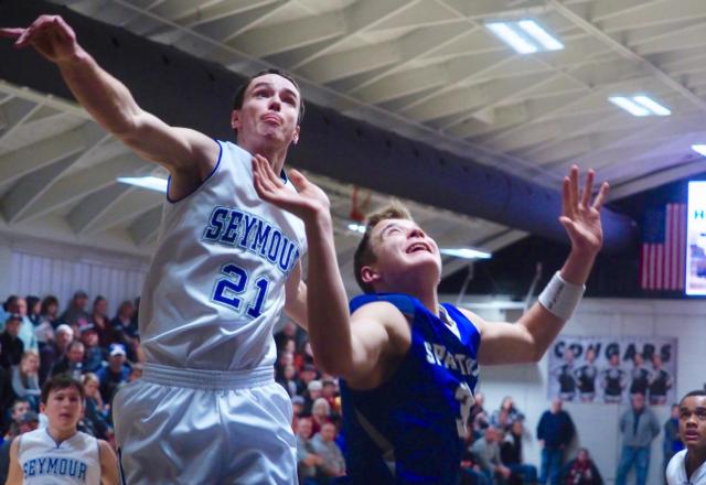 Keaton Brown makes a layup over Turner Voss (21).