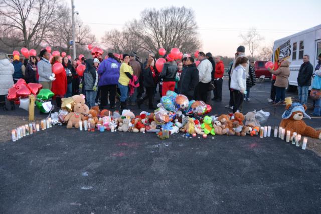 A collection of teddy bears, candles and basketballs were lined up in support of Romell Jones at the candlelight vigil.