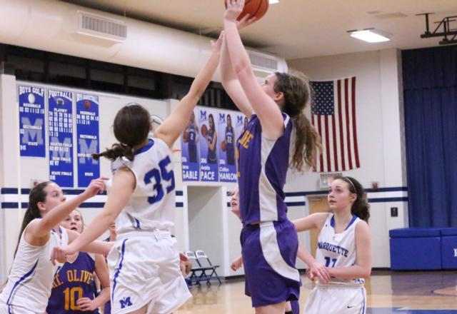 Savannah Bruhn shoots the basket as Lauren Fisher blocks for Marquette.