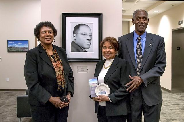 Carolyn Turner, Christiana Shaw and Harry Shaw, pose with a photo of Principal C.C. Jones, during Opening night of the MJCH. Photo by Paige Allen, Lewis and Clark Community College photographer
