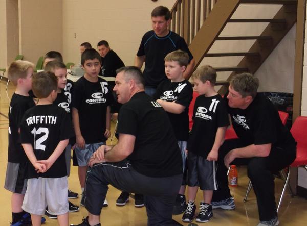 Contegra coaches gather their team during a timeout during the 2nd quarter on Saturday, January 12 to talk strategy during their first game of the season. 