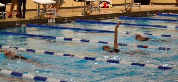 Bailey Grinter and Eilzabeth McPherson are in a tight finish in the 200 backstroke on Sunday.