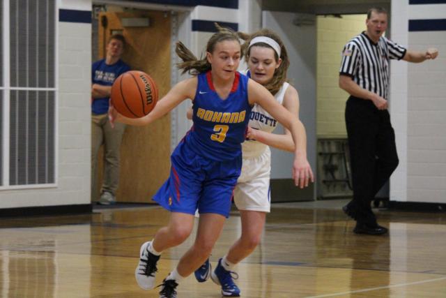 Roxana's Emma Lucas dribbles the ball away from Marquette's Lila Snider