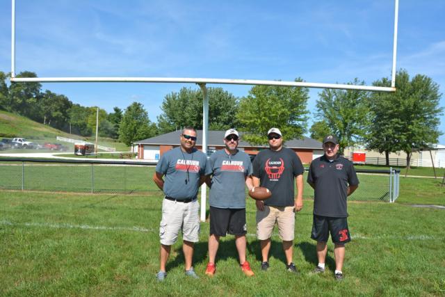 Calhoun coaches stand near the goal line a few years back when Coach Aaron Elmore was taking over the program. (Photo by Dan Brannan)