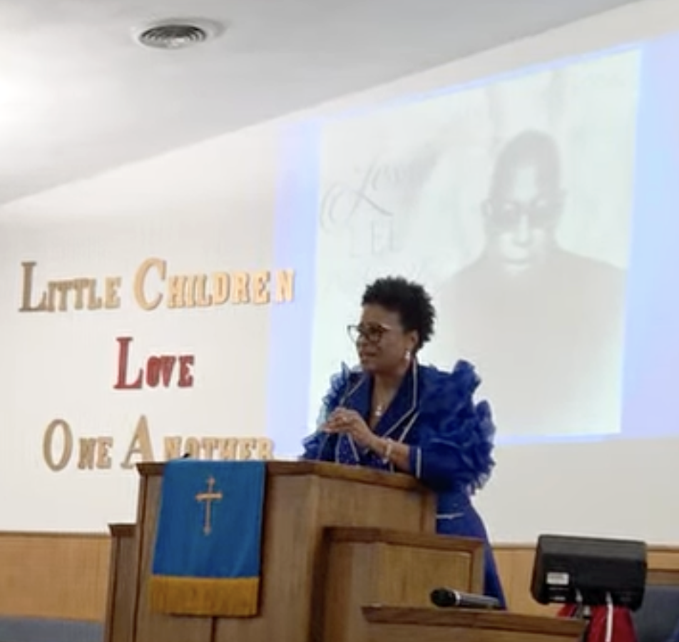Sheila Goins honors Jesse Prather Jr. at the Alton Branch of the NAACP's Martin Luther King event Sunday in Alton.