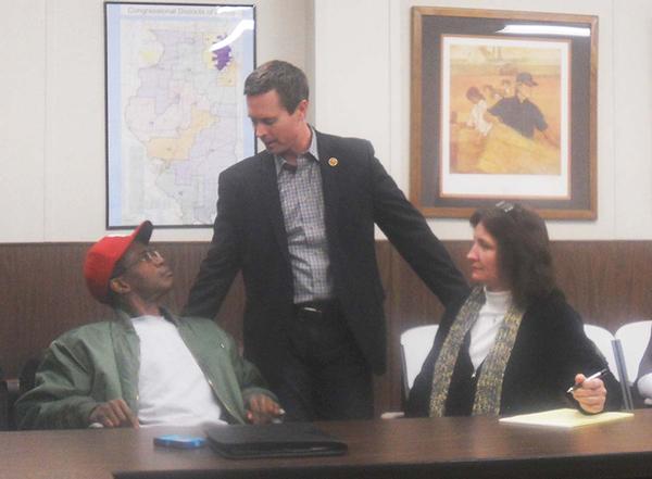 Caption: Congressman Rodney Davis (center) speaks with Village of Royal Lakes Mayor Selone Williams (left) and Village Clerk Vickie Wyman.
