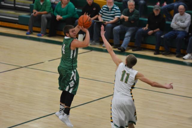 Luke Gillingham sinks a long bucket in Carrollton's triumph on Tuesday night. Gillingham had 15 points in the outing. (Photo by Dan Brannan)