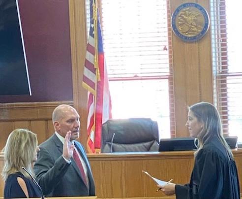 Nick Manns is sworn in as the new Jersey County Sheriff with his wife, Robin, at his side, by Judge Allison Lorton.