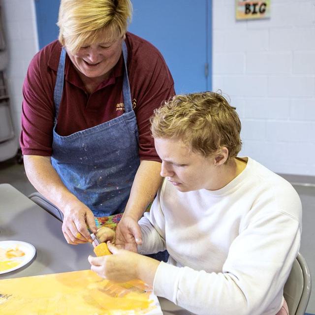 Employee and resident in the art therapy center.