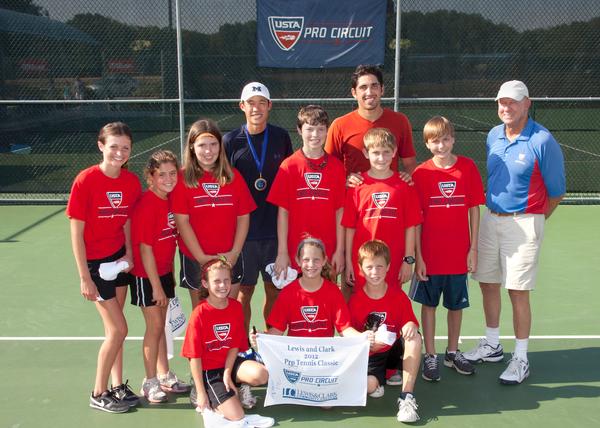 Ball kids pose with singles championship winner American Jason Jung, (in blue) and runner up Cesar Rameriz, of Mexico at Lewis and Clark Community College's 15th Annual USTA Men's Pro Circuit Futures tournament. Photo by S. Paige Allen, Lewis and Clark Community College photographer.