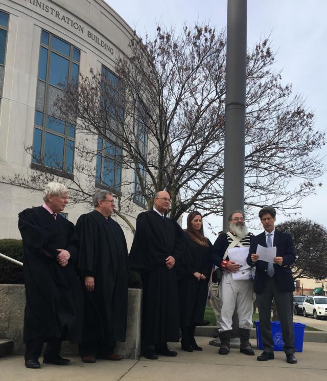 Chairman Kurt Prenzler, far right, reads a proclamation kicking off the Illinois Bicentennial during a flag raising ceremony held my counties and municipalities across the state today. Chief Judge David Hylla, center, attended the event with judges (left to right) Philip Alfred Dennis Ruth and Sarah Smith, along with Madison County Historical Museum Director Jon Parkins.