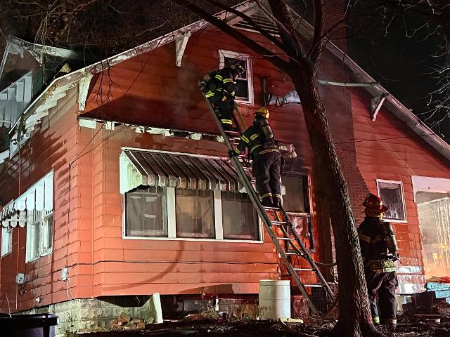 Firefighters battle a blaze in the 600 block of Oak Street on Sunday night. (Photos by John Hentrich)