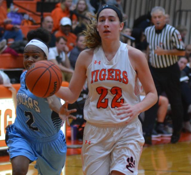 Kate Martin eludes a Belleville East opponent in calm fashion on Monday night at EHS. (Photo by Dan Brannan)