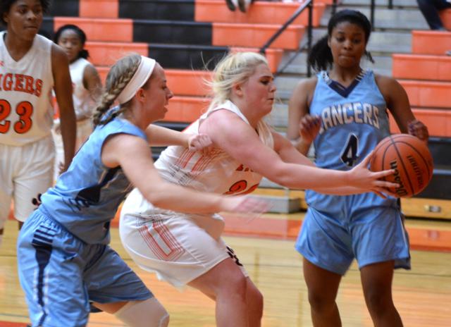 A fight for a loose ball Monday night. (Photo by Dan Brannan)
