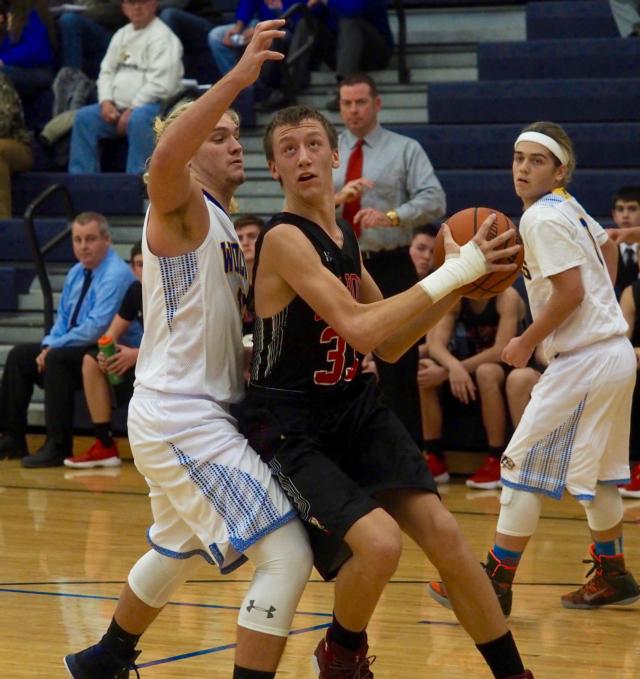 Corey Nelson squaring up against Pleasant Hill's Grant Peebles down low in the paint.