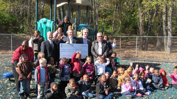  Don Reedy, CEO and President of 1st MidAmerica Credit Union, Alan Meyer COO and Executive Vice President, Greg Worthen, Vice President of Lending and Charity Golf Outing Committee Chairman, and pictured with Chuck Parr, President of RiverBend Head Start & Family Services, and kids from the Alton center.