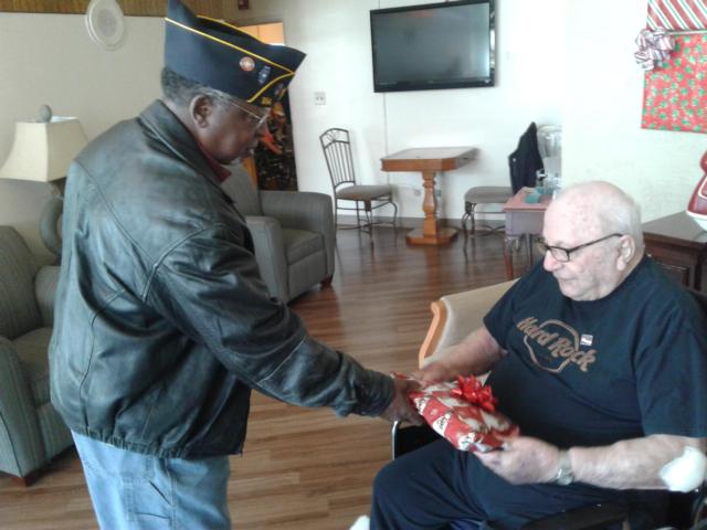 Commander Brice give gift to fellow veteran Carl Markovich