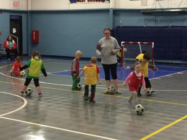 The program instructor, Amanda Kohler, watches as the class participants work on ball-handling skills during the early 2016 class.