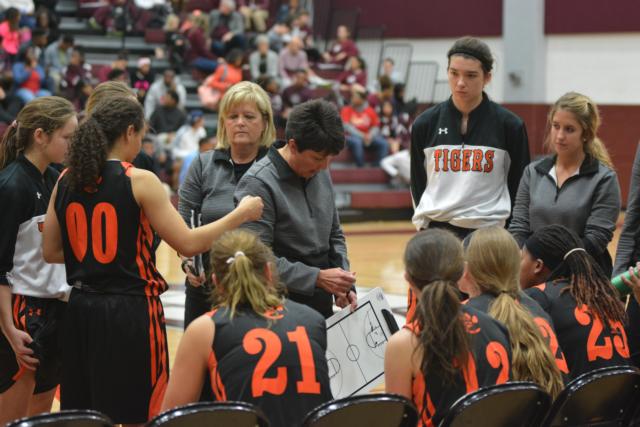 Coach Lori Blade works with her chartboard during a timeout.