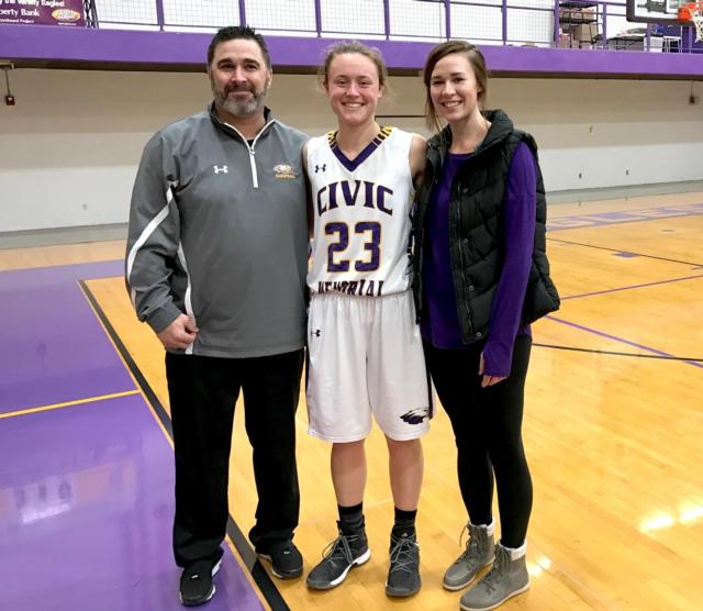 Coach Jonathan Denney, Allie Troeckler and Katie Broadway pose after the game.