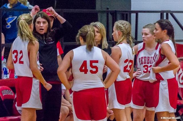 St. John's head coach Robin Klingler schemes with her players during a timeout. Photo curtesy of Mike Weaver.