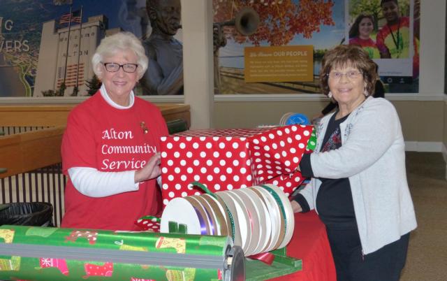 Here, Jean Rathgeb (left) and Sandy Goeken wrap a huge package for a gentlemen who wants to surprise his wife at Christmas.