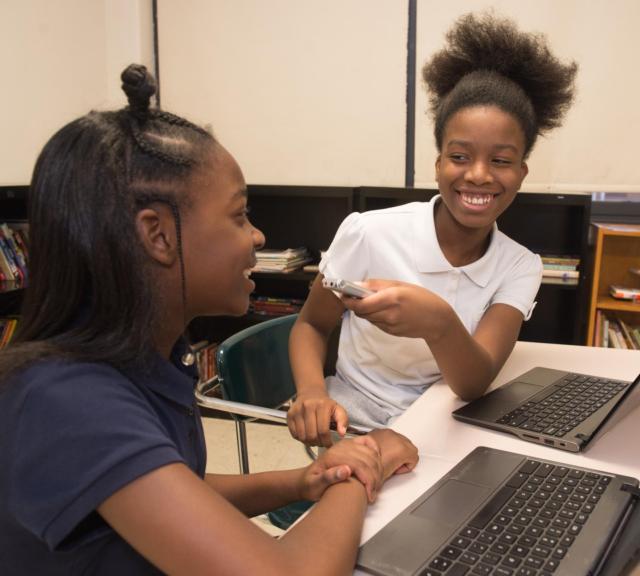 Digital Humanities Club participant Karmen Jackson practices her interviewing skills with classmate Monique Wright.