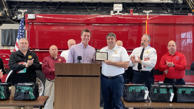 Illinois Fire Safety Alliance Executive Director Philip Zaleski (left) presents an award to O’Fallon Fire Chief Brad White (right) for his department’s participation in the “Be Alarmed!” program at a press conference in O’Fallon.