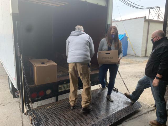  Madison County Board members Denise Wiehardt of Granite City (center) and Chris Hankins of Pontoon Beach (right) help unload a box truck of food and non-perishables that Madison County employees donated this holiday season to Community Care Center in Granite City to help those less fortunate. Madison County employees collected 2.5 tons to be donated to local food pantries this holiday season.