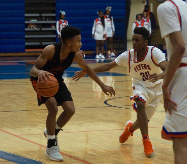 Malik Robinson looks for an opening as he's guarded by Iminique Williams (30).