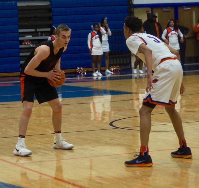Caleb Strohmeier in the back-court being guarded by Joe Reece.