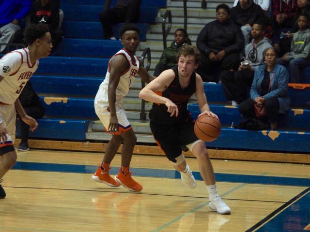 Jack Marinko drives past a defender on the baseline in the second half against East St. Louis.