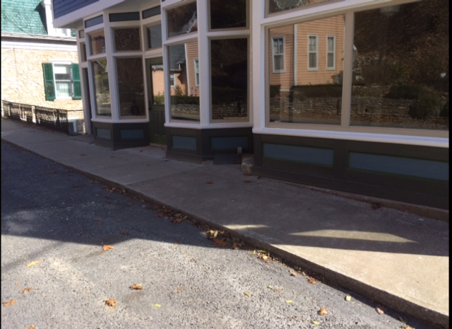 Front and sidewalk (after painting) where repair of original quarry stone foundation and replacement of sidewalk will occur, with matching funds provided by Landmarks Illinois