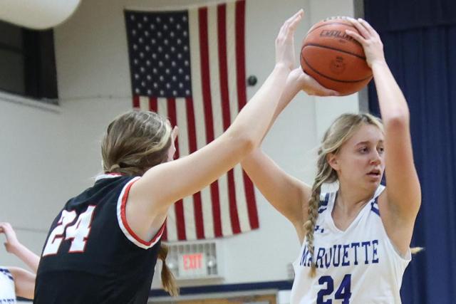 Marquette senior Olivia Kratcchmer tries to get past a Highland defender in a game earlier this season. (Photo credit: Bradley Piros)