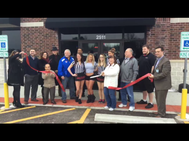 A ribbon is cut at Hotshots Bar & Grill.