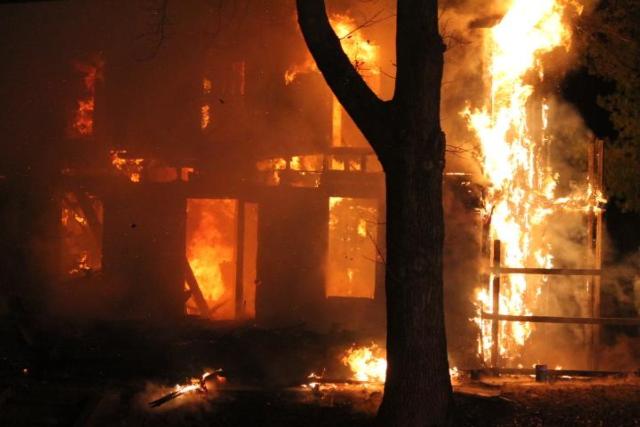 A home on 9th Street in Alton was fully involved in flames when firefighters arrived Thursday night. However, firefighters quickly extinguished the blaze and prevented a second house from catching fire. (All photos by Chris Rhodes)