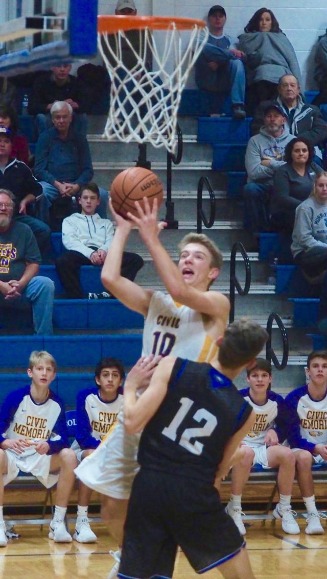 Bryce Zupan attacks the basket while getting defended by Drew Worley.