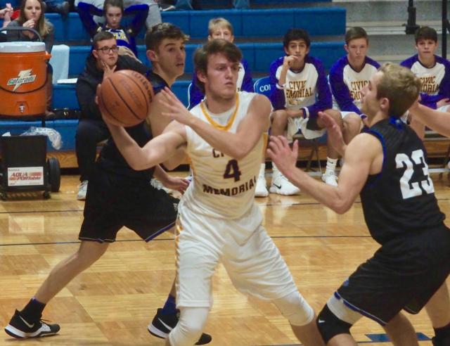 Jacob Coleman passes out of a trap as he's under the basket.