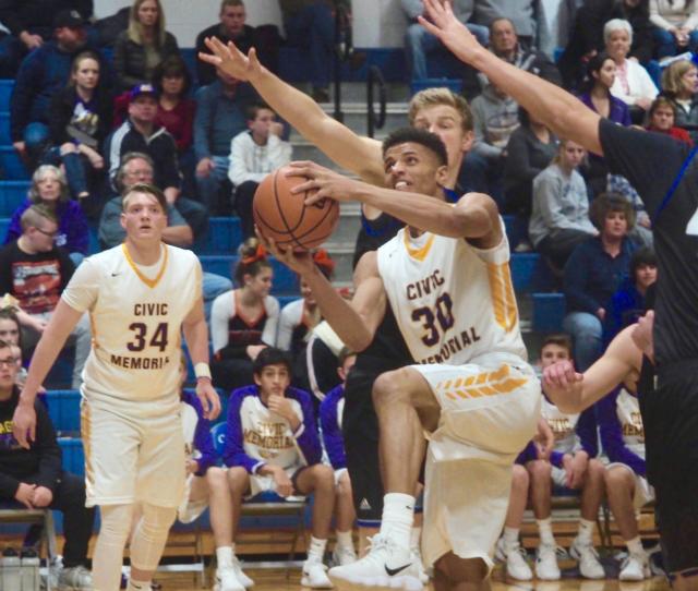 JaQuan Adams flies in to convert a layup for Civic Memorial against Columbia in the Columbia-Freeburg Holiday Tournament.