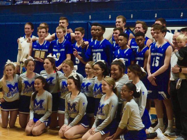 The Marquette Catholic Explorers posing for pictures after winning the Columbia-Freeburg Holiday Tournament.
