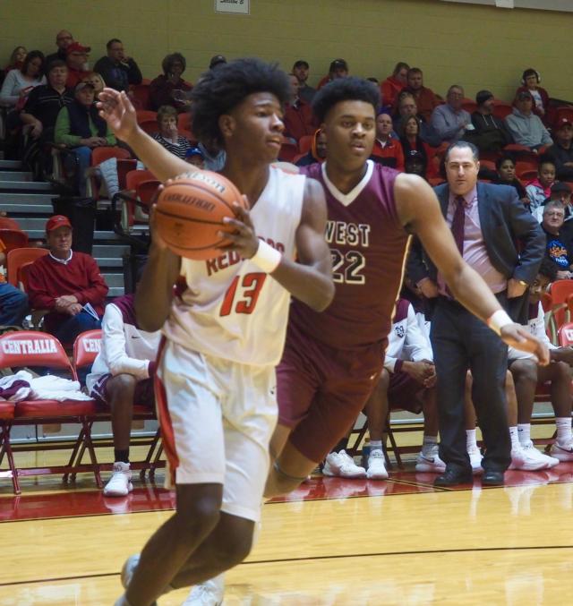 Malik Smith drives past Randolph Jr. on the baseline looking for an open teammate.