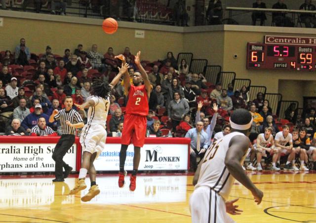 Alton's Kevin Caldwell hits a last-second shot to win the game against Carmel Catholic.