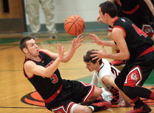 Brandon Fraley and Blake Booth try to retain a loose ball in a recent Carrollton Holiday Tourney game.